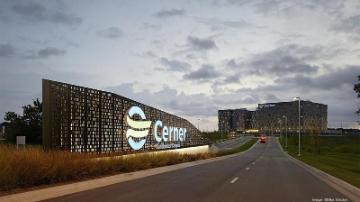 Entrance to Cerner office building with road and overcast sky. image link to story