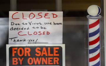 barbershop with a closed for business and for sale sign in window image link to story