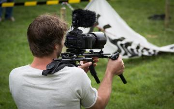 Camera man holding a camera image link to story