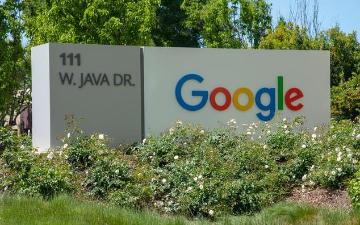 Google sign outside building surrounded by greenery. image link to story