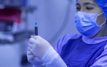 A medical professional preparing an injection. image link to story