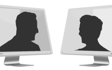 Silhouettes of two people facing each other through computer monitors. image link to story