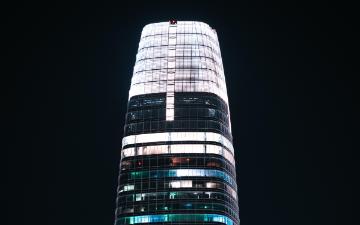 Salesforce Tower illuminated against the night sky. image link to story