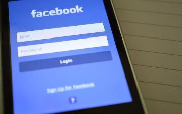 Smartphone screen displaying Facebook login page with email and password fields. image link to story