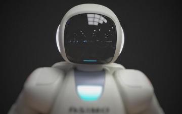 A humanoid robot with a dark face panel display. image link to story