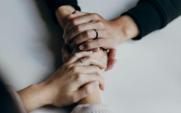 Hands holding image link to story