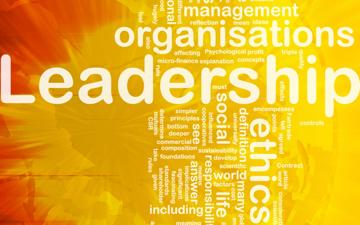 Leadership and related words on bright, yellow-orange background.