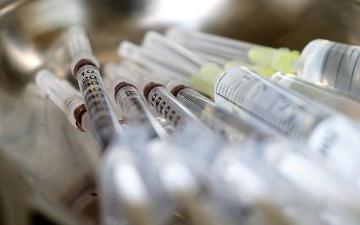 Close-up of multiple syringes with needles capped. image link to story