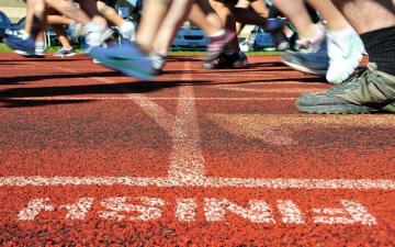 Runners feet on a track near the finish line. image link to story