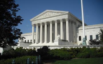The U.S. Supreme Court building with columns and a flagpole. image link to story