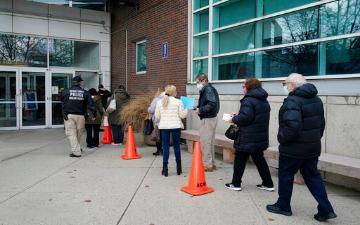 health care workers stand in line for vaccine distribution in New York in January, 2021 image link to story