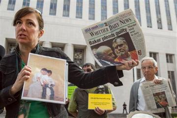 Survivor Joelle Casteix of Newport Beach, Calif., and SNAP Western Regional Director, left, holds photographs of jailed perpetrator Rev. Michael Stephen Baker as she joins members of SNAP, the Survivors Network of those Abused by Priests, during a news conference outside the U.S. Attorney’s office in Los Angeles, Wednesday, Feb. 6, 2013. Thousands of pages of confidential priest personnel files re