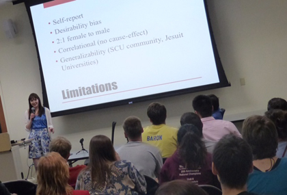 People attending a presentation with a slide titled 