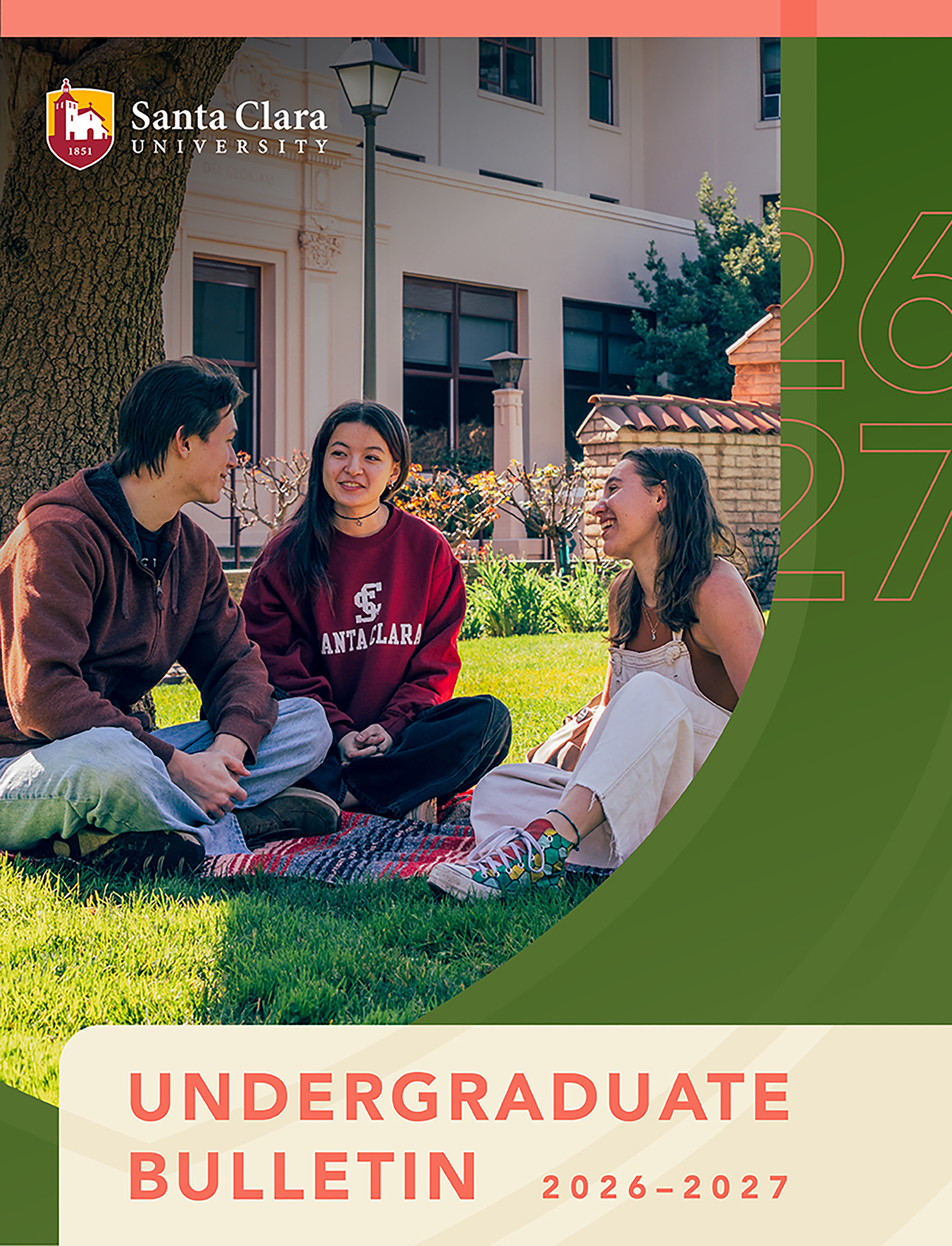Three college students are sitting in a circle on a blanket on a grassy campus lawn, talking and laughing together. One student wears a red Santa Clara sweatshirt. In the background is a Spanish-style campus building under bright sunlight. The top-left corner features the Santa Clara University logo. A green graphic overlay on the right displays the outline of the numbers 26 and 27.