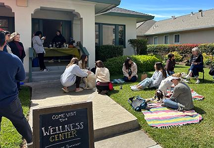 Image of interacting people outside of wellness center 