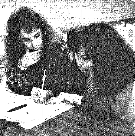 Santa Clara student Wendy Traiger (left) helps a student learning English as a Second Language at Overfelt Adult Center.