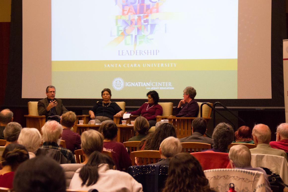 People attending a 'Lulu Panel' discussion in an auditorium.