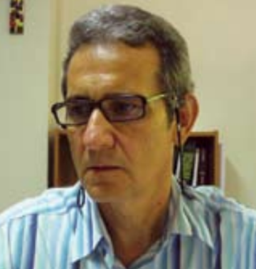 A person wearing glasses with a striped shirt.