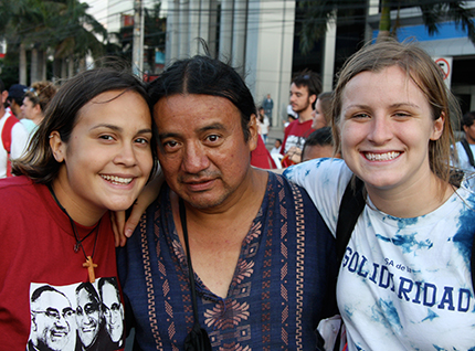 Three people smiling together outdoors, titled 