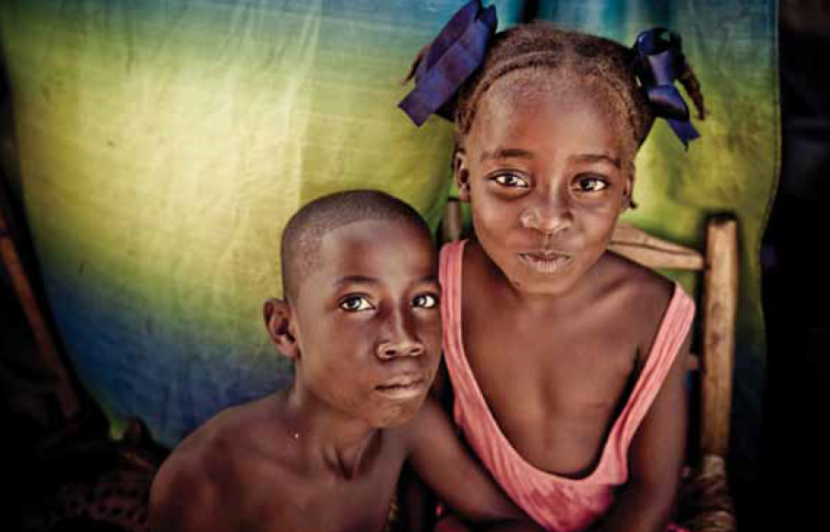 Two children with a colorful background.