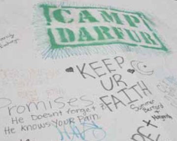 Global Solidarity 2 written messages and drawings on a white surface, including Camp Darfur.