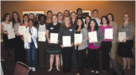 Group of people holding certificates posing for a photo.