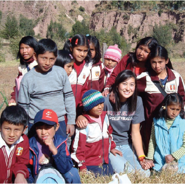 A group of people posing outside in a natural setting.
