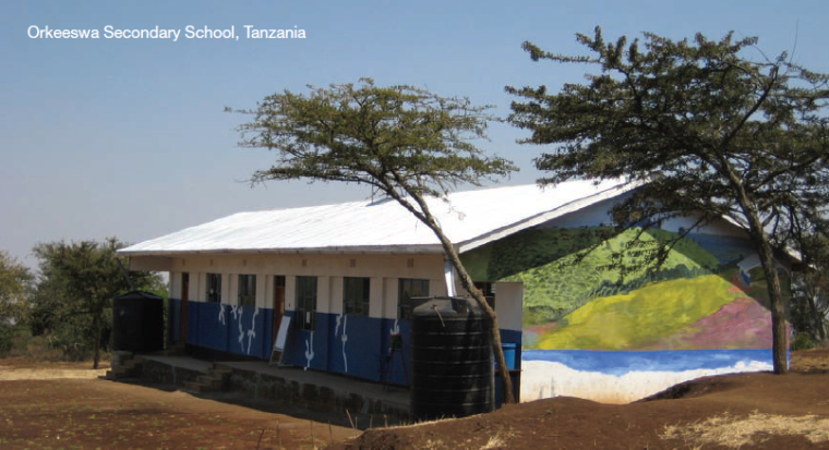 Alt text: Painted secondary school building with trees in Tanzania.
