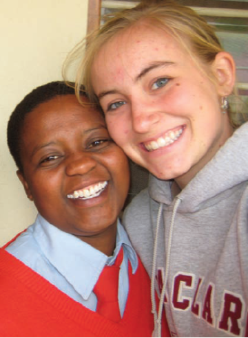 Two people smiling, one wearing a red sweater; image titled 'hilary with student'.