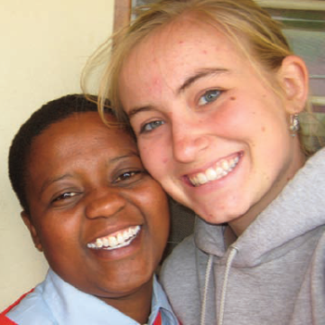Two people smiling together, close-up.