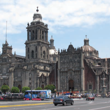 Mexico City Metropolitan Cathedral with surrounding traffic and people.