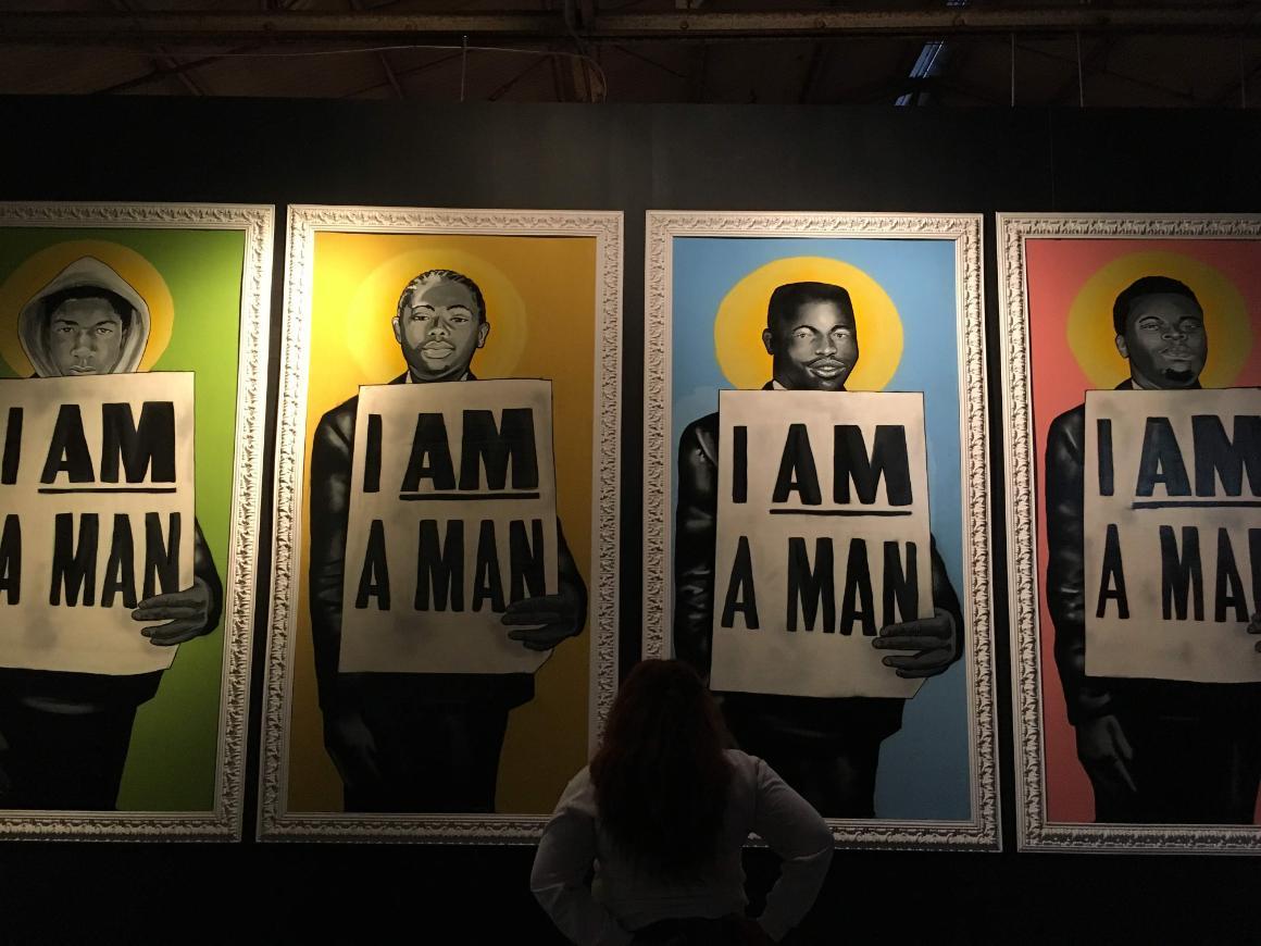 Art display of four men holding 