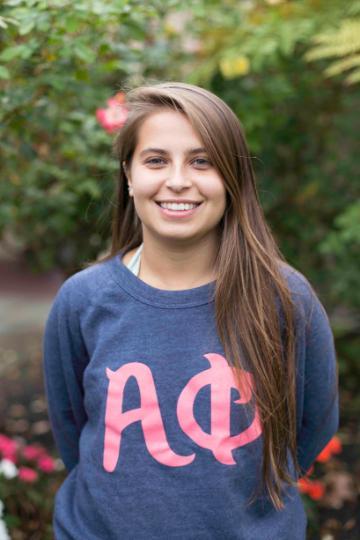 A person in a sweatshirt with Greek letters 