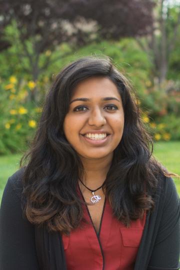 Smiling person in a garden.