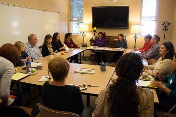 A group of people having a meeting in a conference room.
