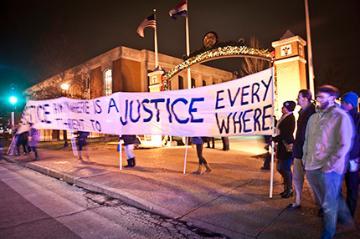 Protesters holding a banner that says 