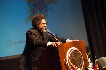 A person speaking at a podium with a logo.