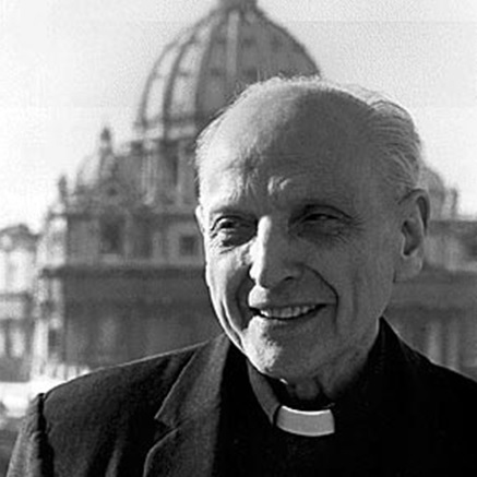 A priest standing in front of a dome building.