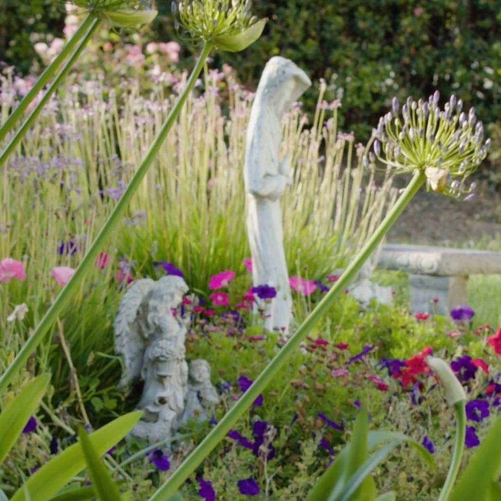 Villa Maria Retreat Center Garden with statures of an angel and Mary image link to story