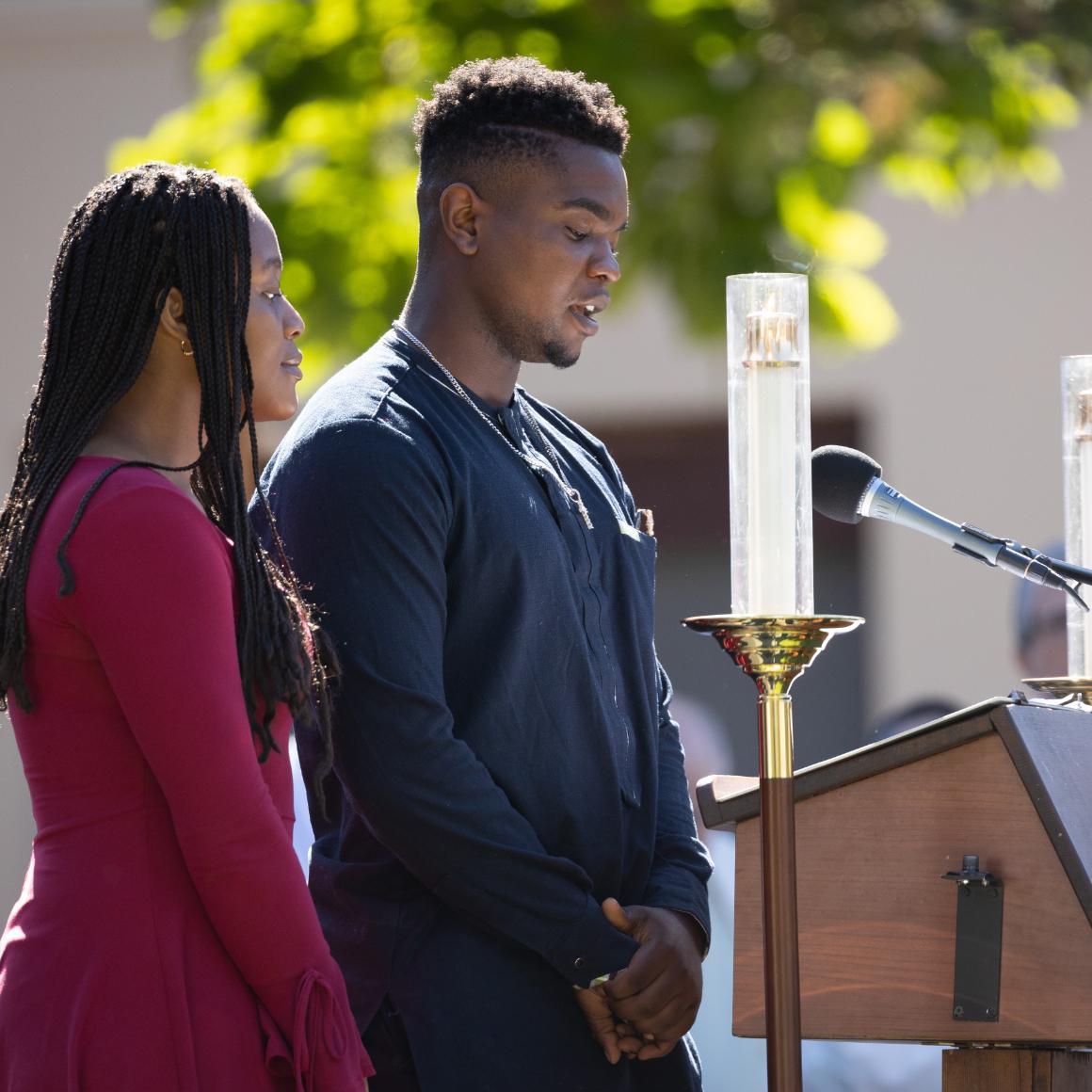Students doing a reading at the Welcome Weekend Mass image link to story