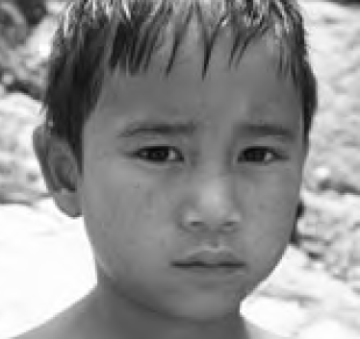 A black and white photo of a young child.