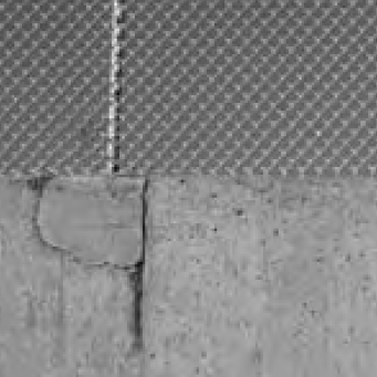 Concrete wall with chain-link fence on top. image link to story