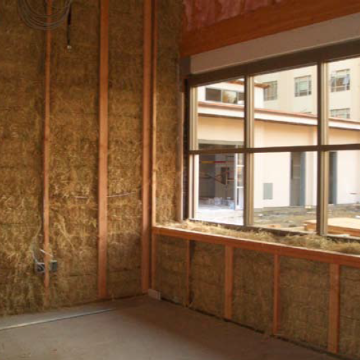 Construction site with exposed insulation and a window frame. image link to story