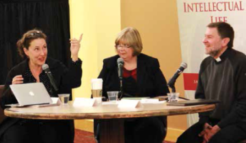 Three people having a discussion at a round table.