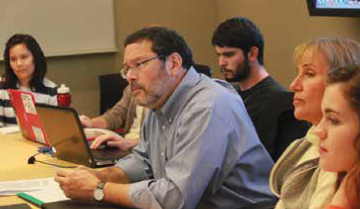 A group of people in a meeting room.