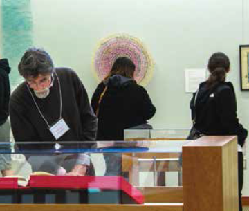 People observing displays in an art or science museum.