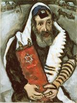 A rabbi holding a Torah.