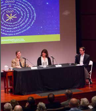 Three people on stage at a panel discussion.