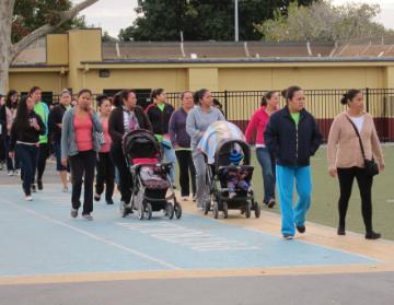 A group of people walking outdoors near buildings.