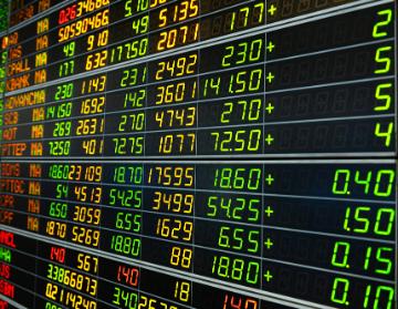 Stock market display with various financial data and numbers.